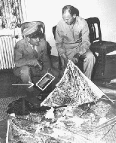 Gen. Roger Ramey (kneeling) and chief of staff Col. Thomas Dubose posed with weather balloon and radar reflector, July 8, 1947, Fort Worth, Texas. Some claim text contained on the paper in Ramey's hand (boxed) confirms an alien recovery. See enlargement to the left.